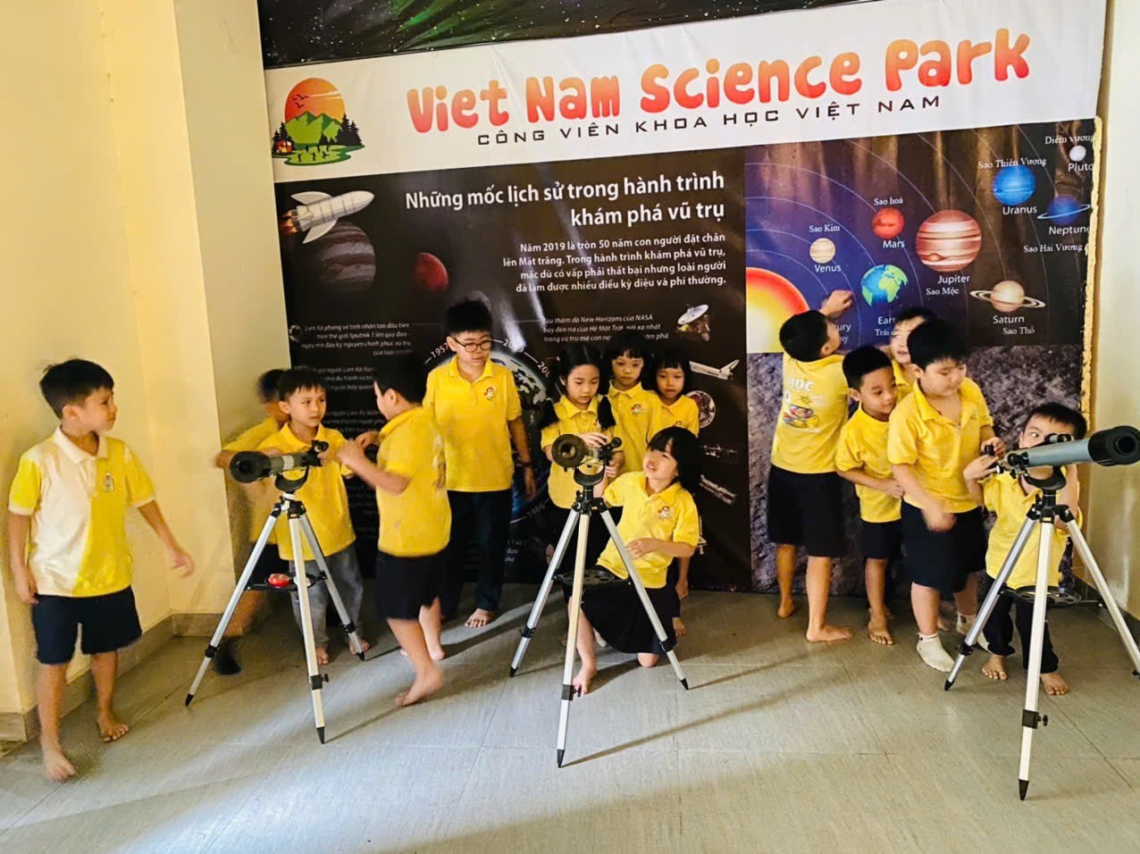 A group of children in yellow shirts

Description automatically generated