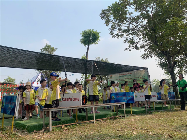 A group of children standing under a canopy

Description automatically generated