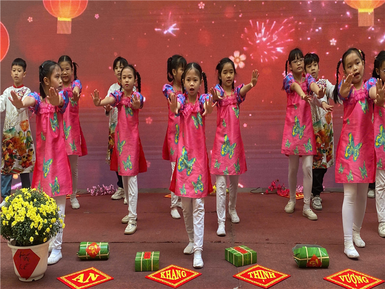 A group of young girls dancing on a stage

Description automatically generated