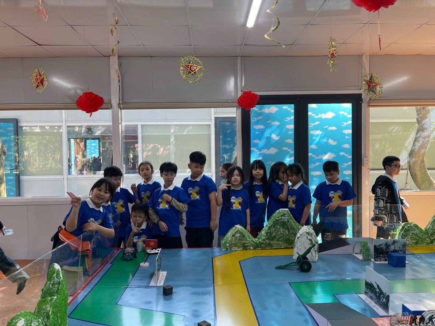 A group of children standing in a room

AI-generated content may be incorrect.