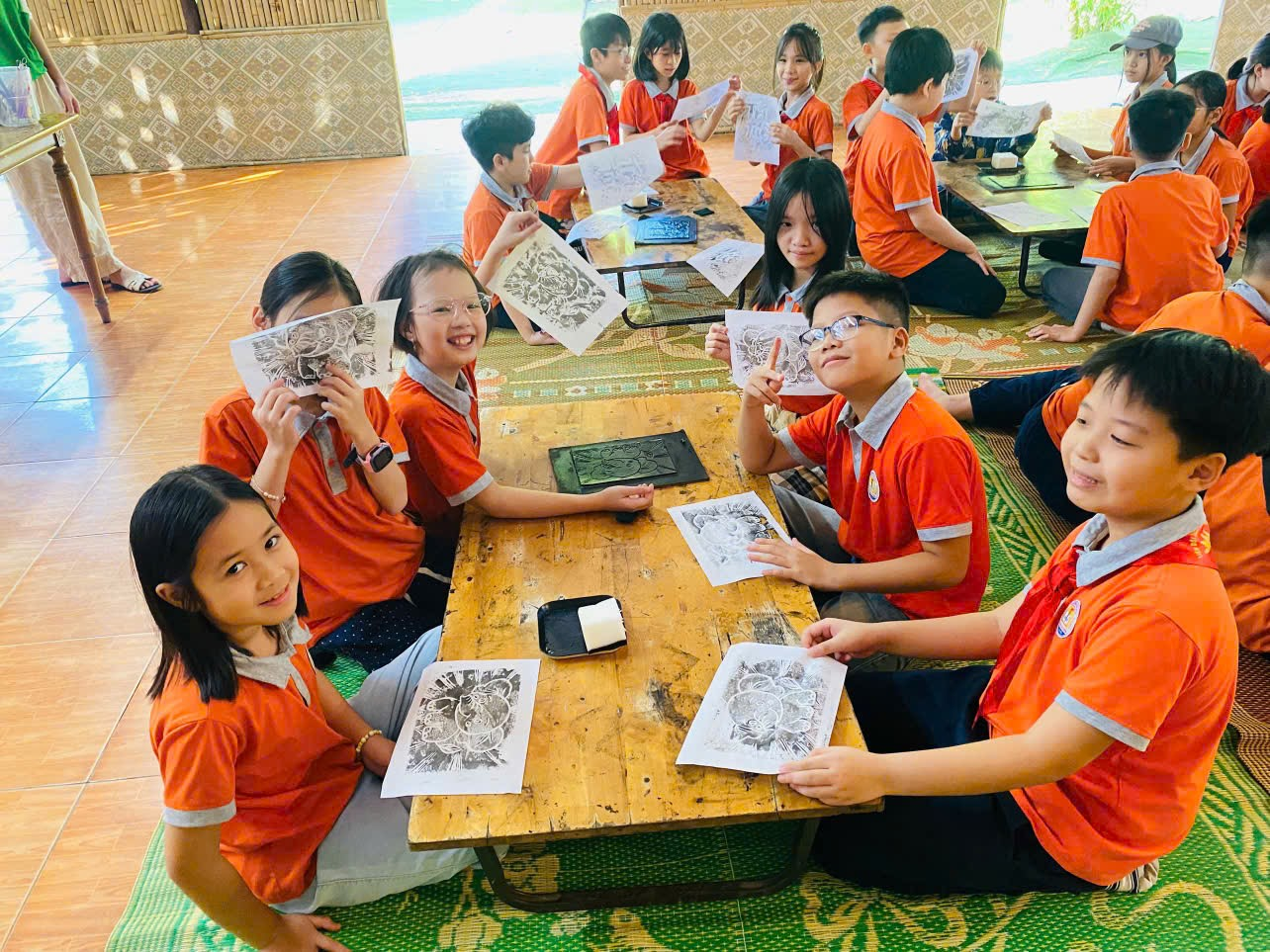 A group of children sitting around a table

AI-generated content may be incorrect.